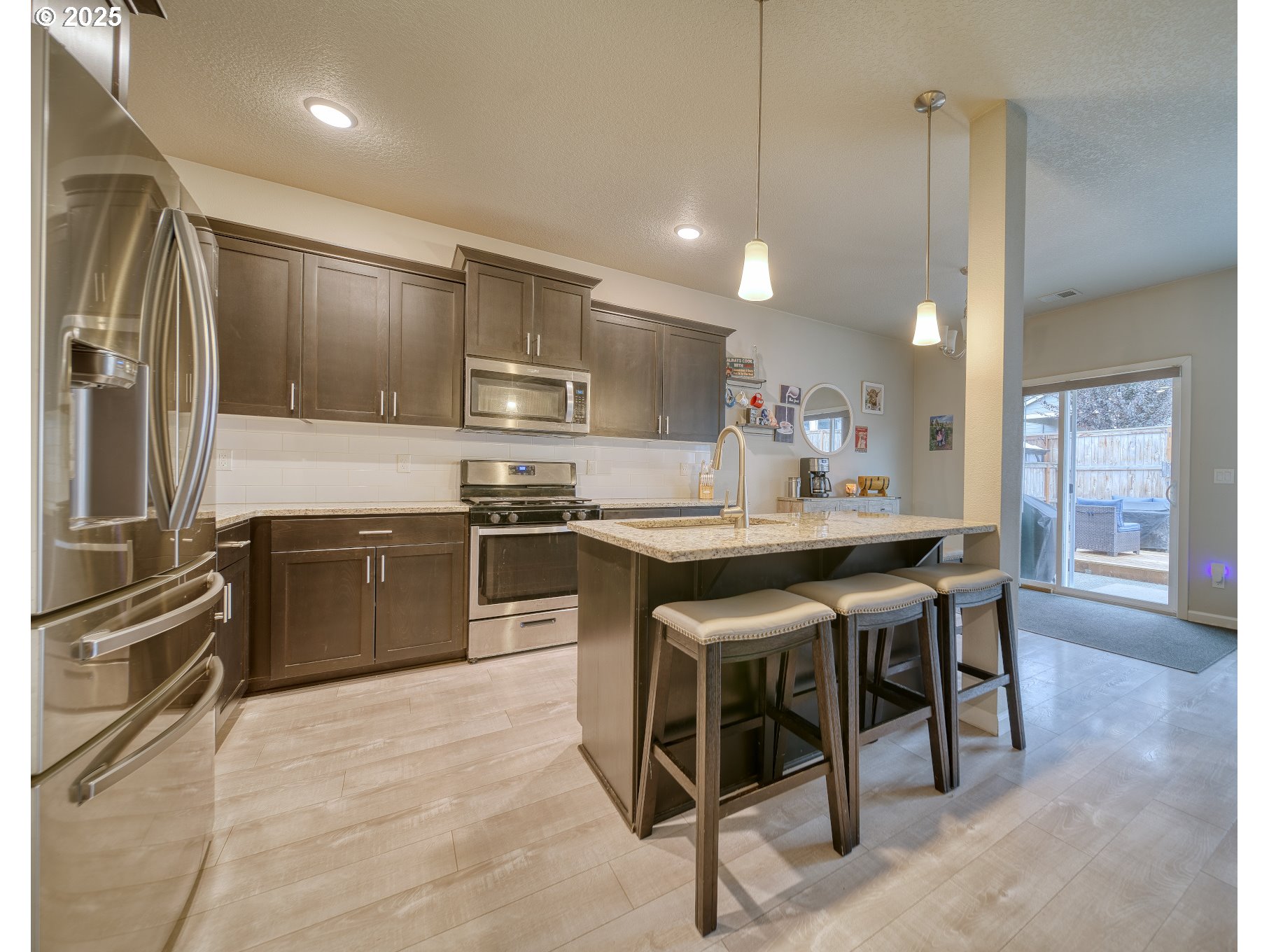 175 Kindre Street St. Helens, OR 97051 - Photo 10 of 22 a kitchen with kitchen island a sink stove and refrigerator