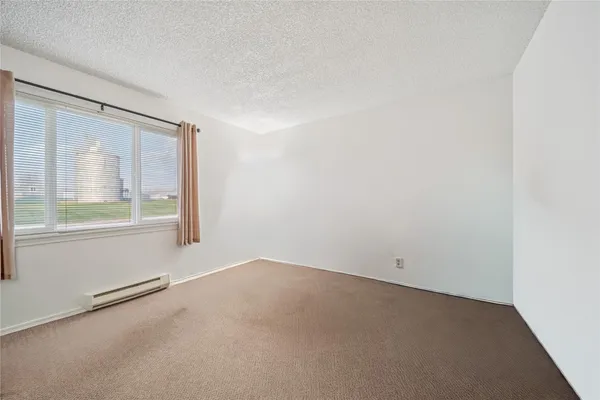 a view of a room with wooden floor and chair