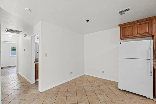 a view of a kitchen with a refrigerator