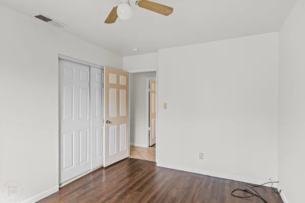 an empty room with wooden floor