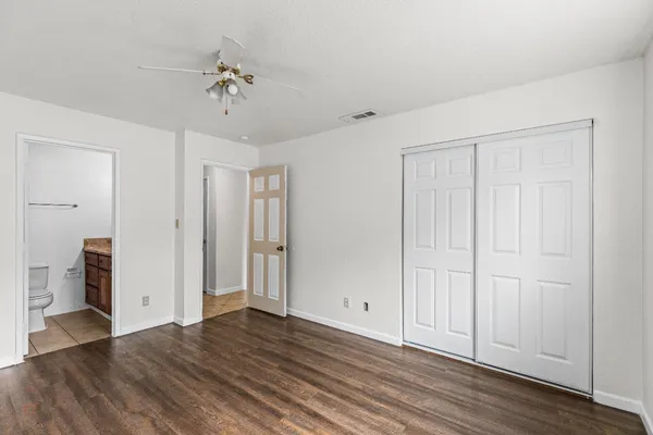 a view of an empty room with wooden floor