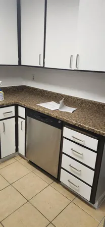 a kitchen with stainless steel appliances a refrigerator sink and cabinets