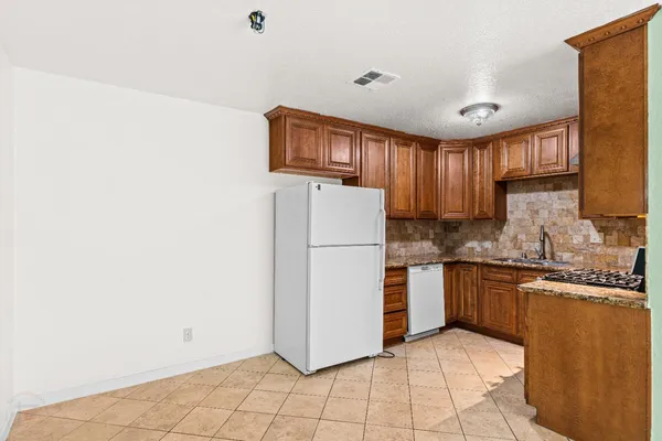 a kitchen with stainless steel appliances granite countertop a refrigerator sink and cabinets