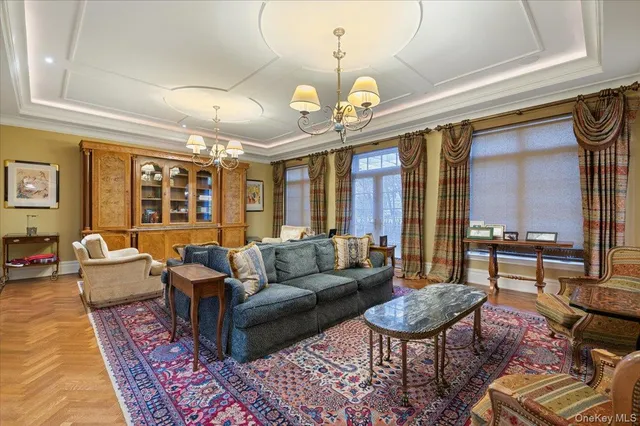 a living room with furniture a rug and a chandelier