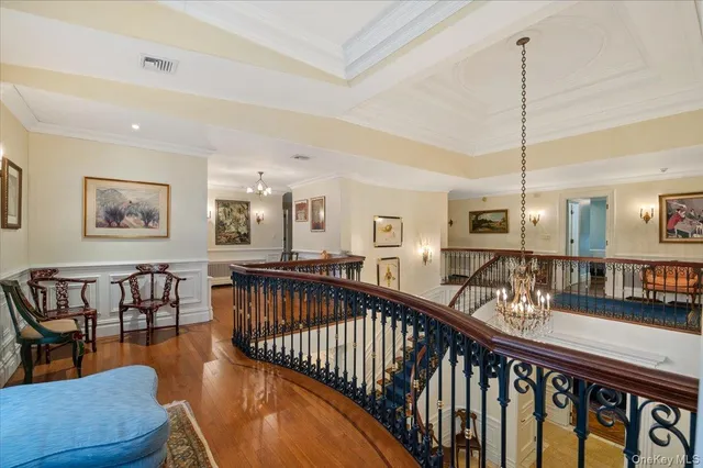 a spacious bedroom with a bed and a flat screen tv