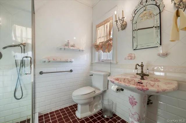 a bathroom with a sink toilet and mirror