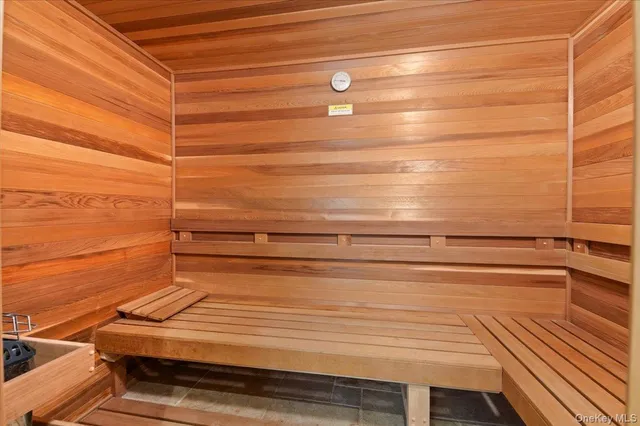 an empty room with a ceiling fan and window