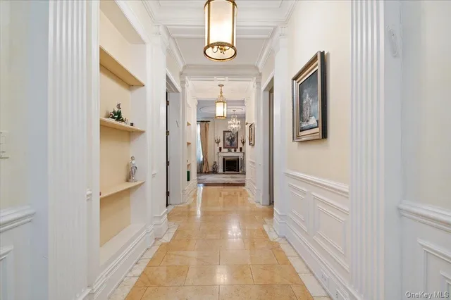 a view of hallway with wooden floor and windows
