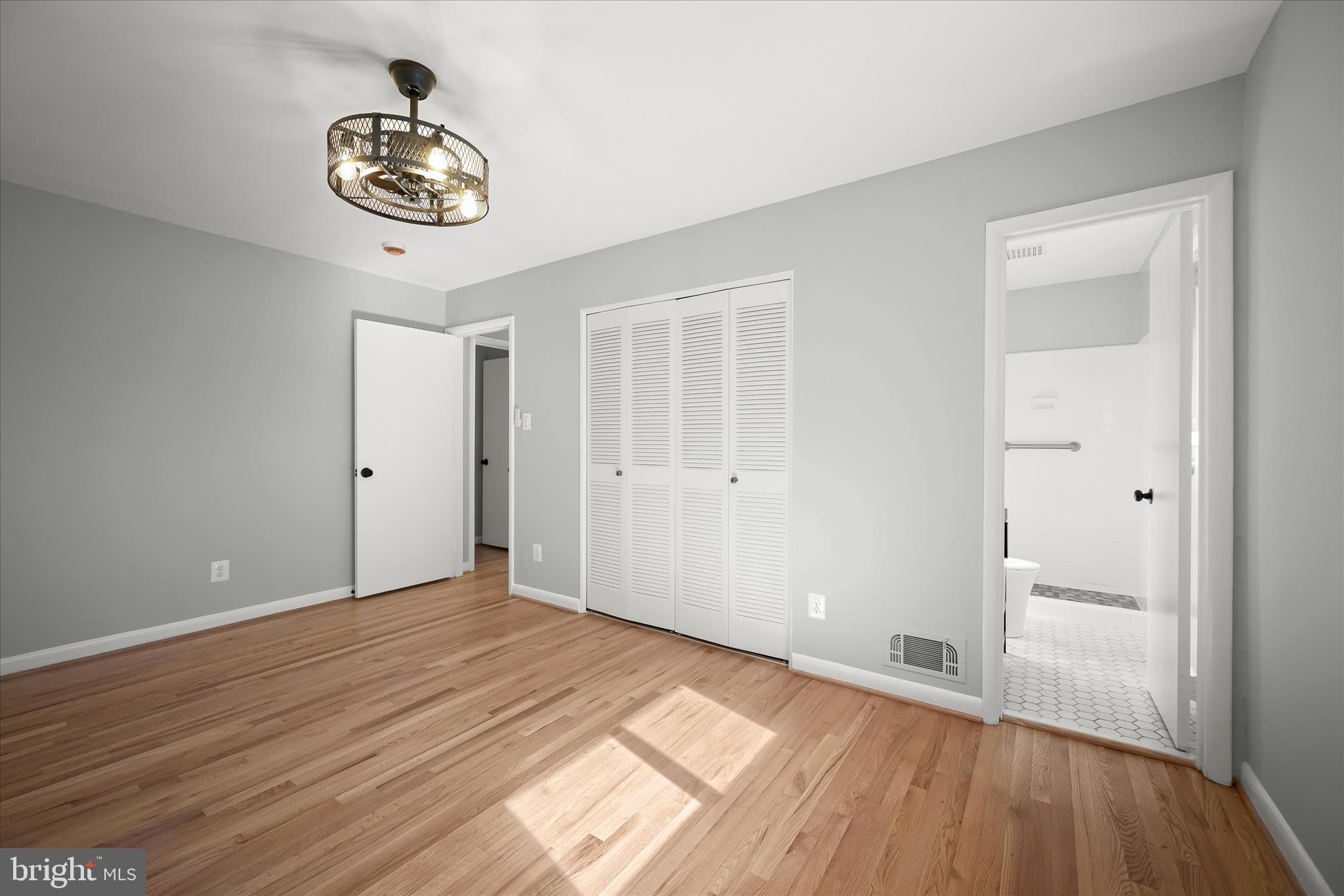 9720 Hedin Drive Silver Spring, MD 20903 - Photo 34 of 79 a view of a room with wooden floor and white walls