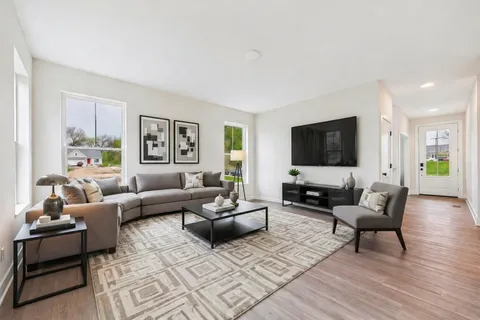 a living room with furniture and a flat screen tv