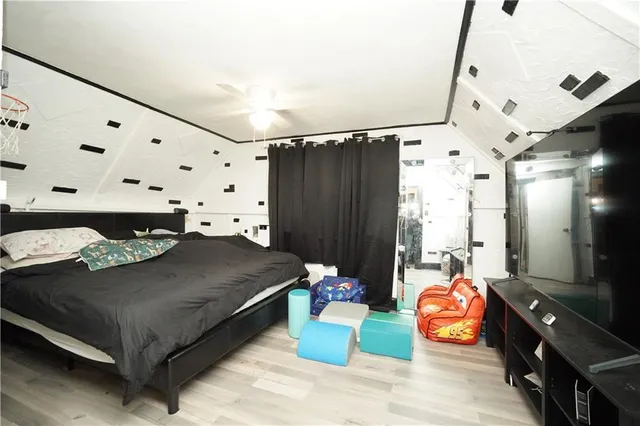 a bedroom with furniture and a large mirror