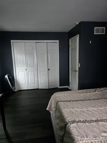 a bedroom with a bed and a cabinets