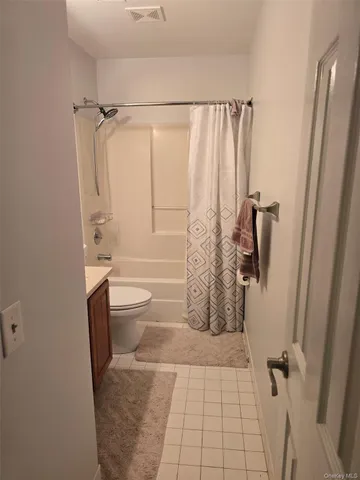 a bathroom with a shower toilet and sink