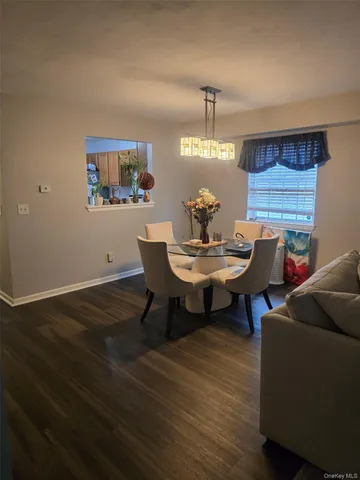 a view of a dining room with furniture and chandelier