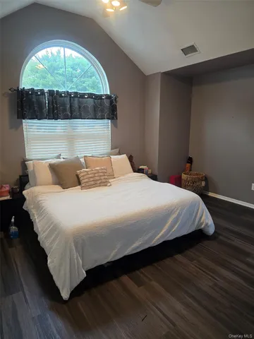 a bedroom with a bed and a large window