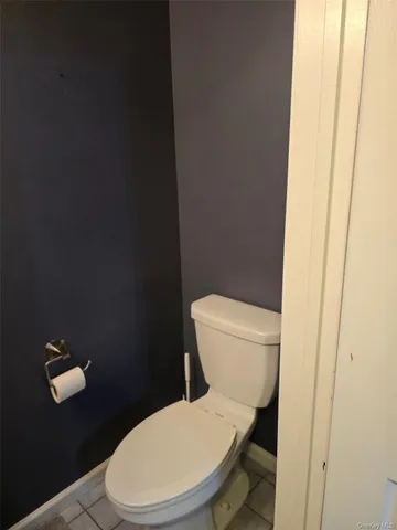 a white toilet sitting next to a shower