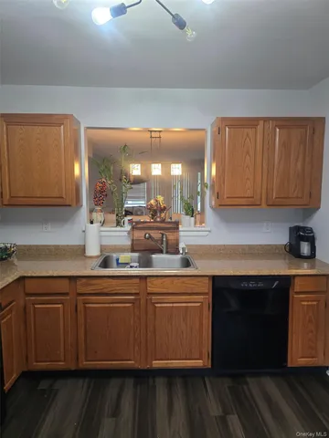 a kitchen with a sink cabinets and wooden floor