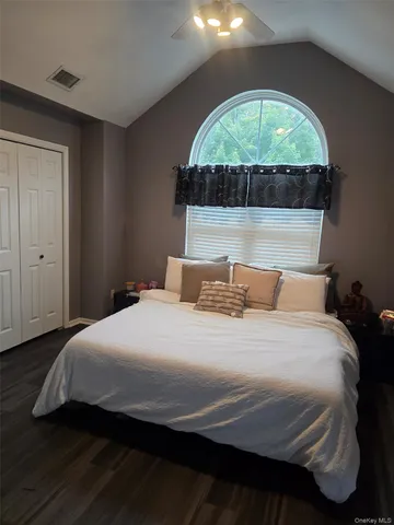 a bedroom with a bed and a large window