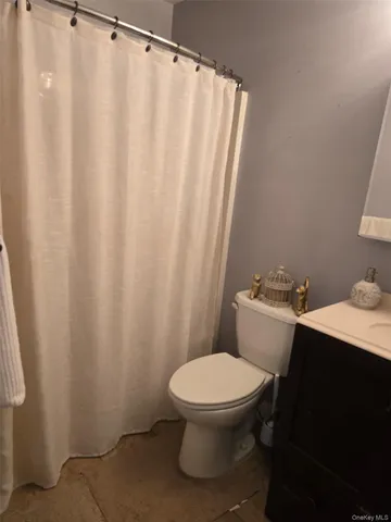 a white toilet sitting next to a shower curtain