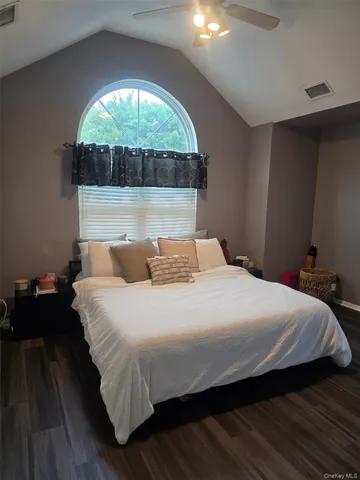 a bedroom with a bed and a large window