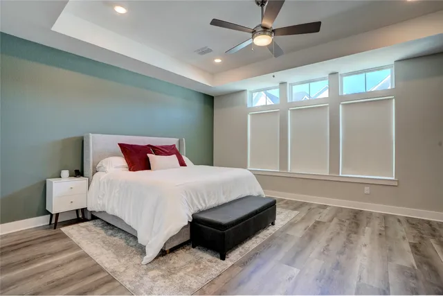 a bedroom with a large bed and a large window