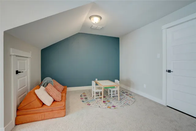 a bedroom with a bed couch and a window