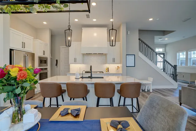 a living room with furniture kitchen view and a potted plant