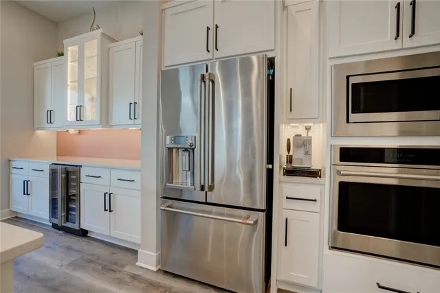 a kitchen with stainless steel appliances a refrigerator stove and cabinets