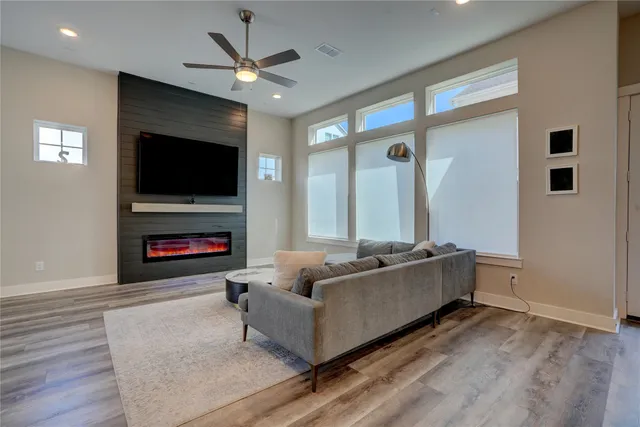 a living room with furniture a fireplace and a flat screen tv