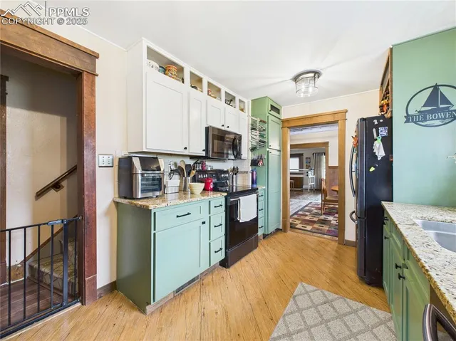 a kitchen with stainless steel appliances granite countertop a refrigerator stove and sink