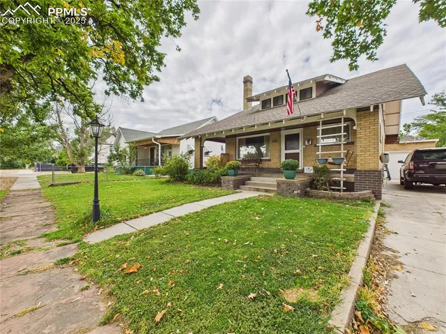 a view of a house with backyard sitting area and garden