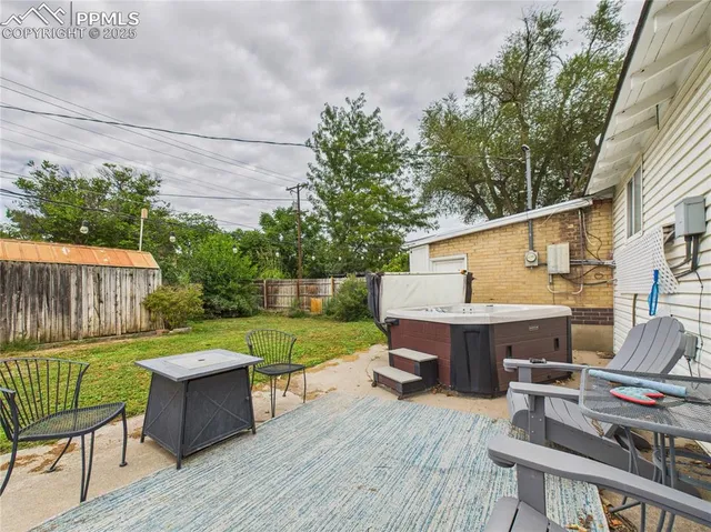 a view of a deck with furniture and a backyard