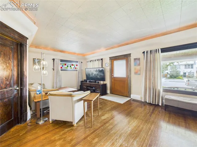 a living room with stainless steel appliances kitchen island granite countertop a sink and cabinets