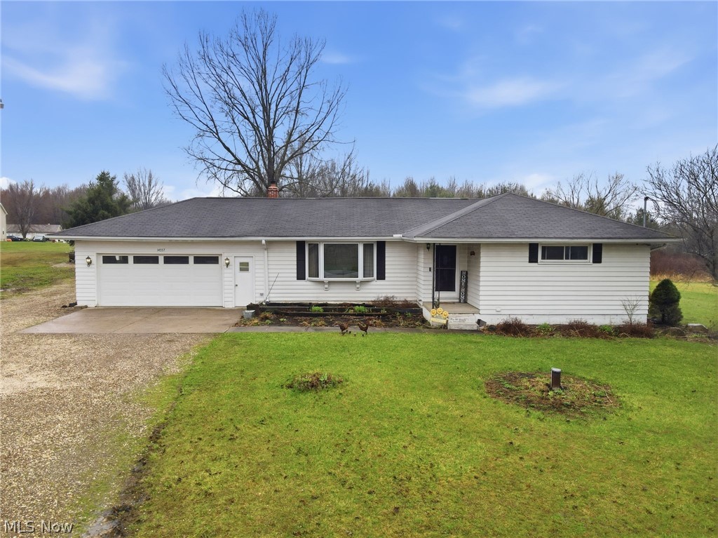 14557 Ellsworth Road Berlin Center, OH 44401 - Photo 1 of 23 Ranch-style home with driveway, an attached garage, and a front yard