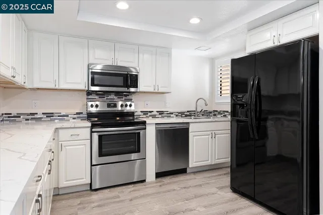 a kitchen with a refrigerator stove and sink