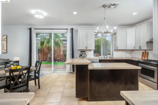 a kitchen with stainless steel appliances granite countertop a sink a stove and a refrigerator
