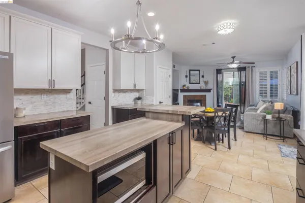 a kitchen with stainless steel appliances granite countertop a sink and a refrigerator