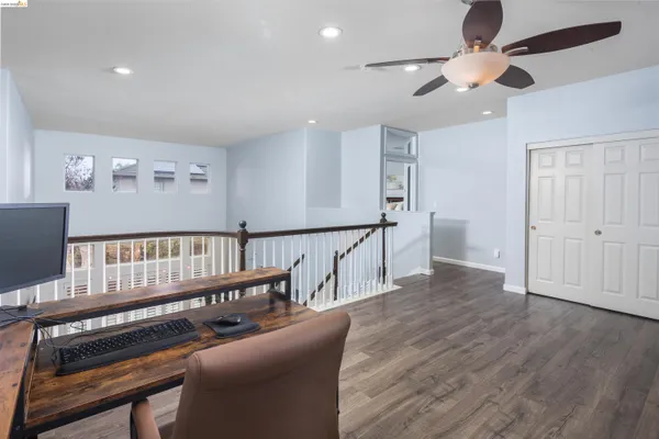a spacious bedroom with a bed and a chandelier