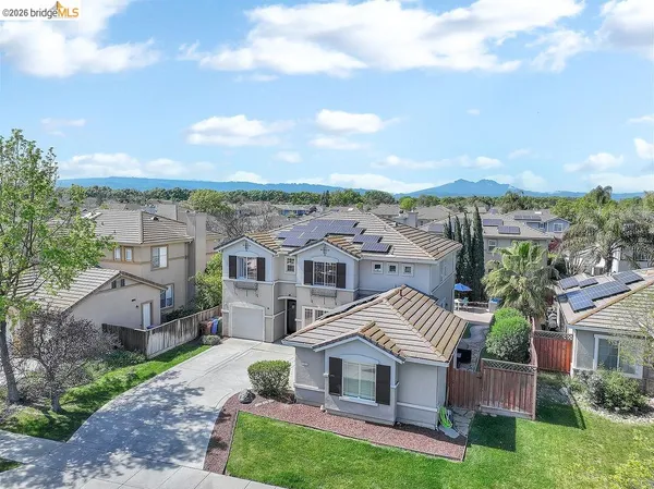 a view of a house with a yard and balcony
