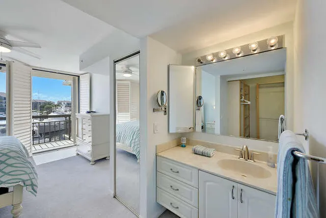 a spacious bathroom with a granite countertop sink mirror and shower
