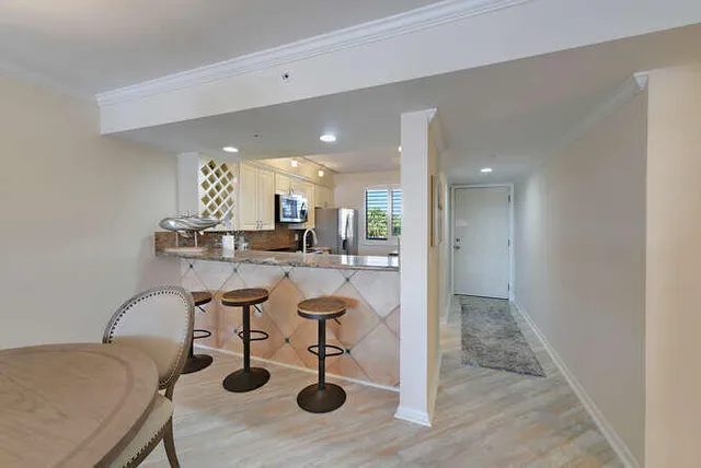 a kitchen with a sink cabinets and dining table