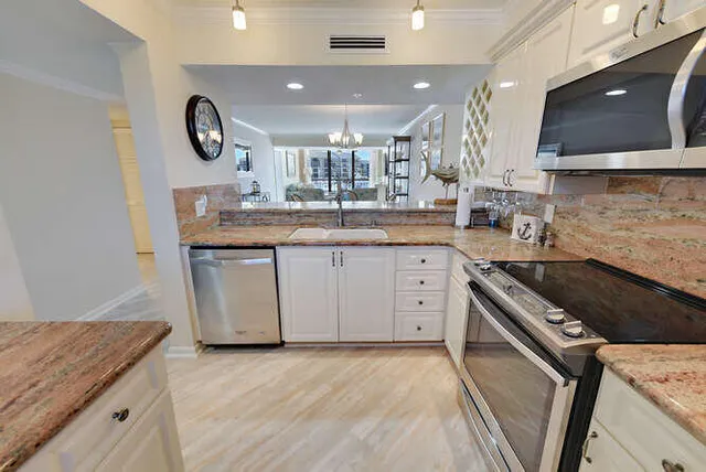 a kitchen with a sink stove top oven and cabinets