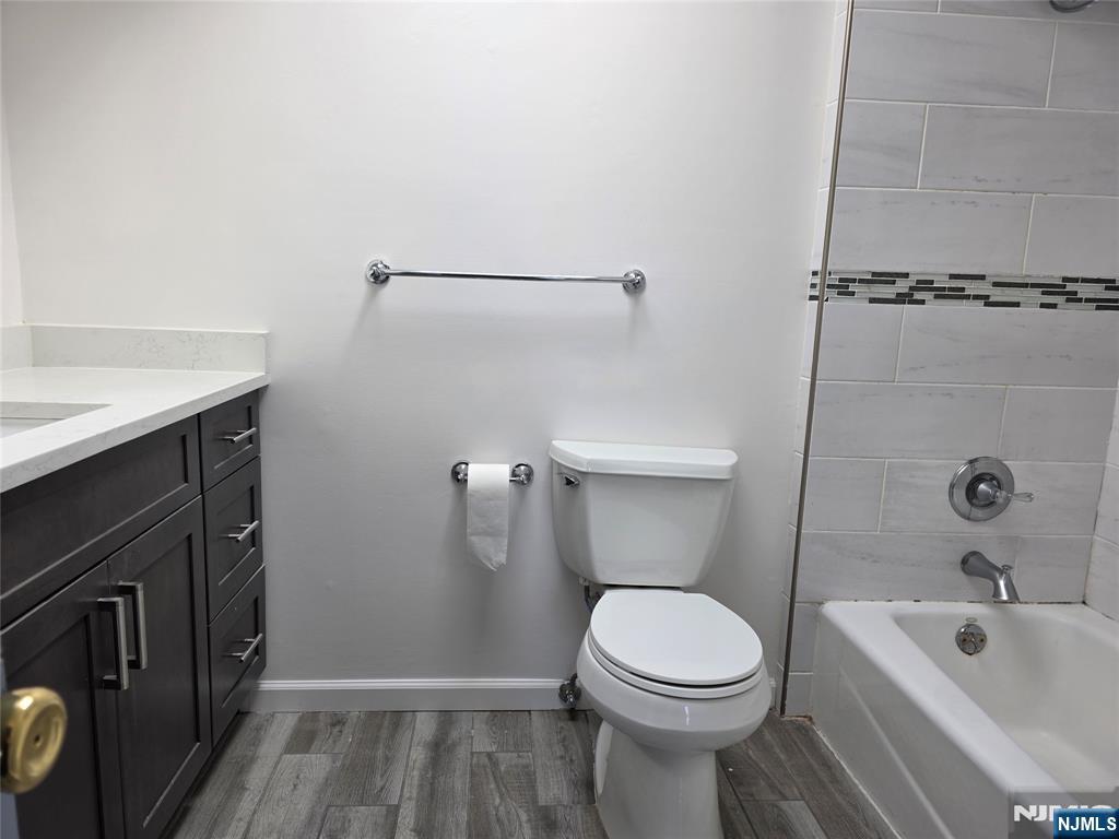 320-322 Williams, Unit 322 Hasbrouck Heights, NJ 07604 - Photo 11 of 12 a bathroom with a sink a toilet and shower