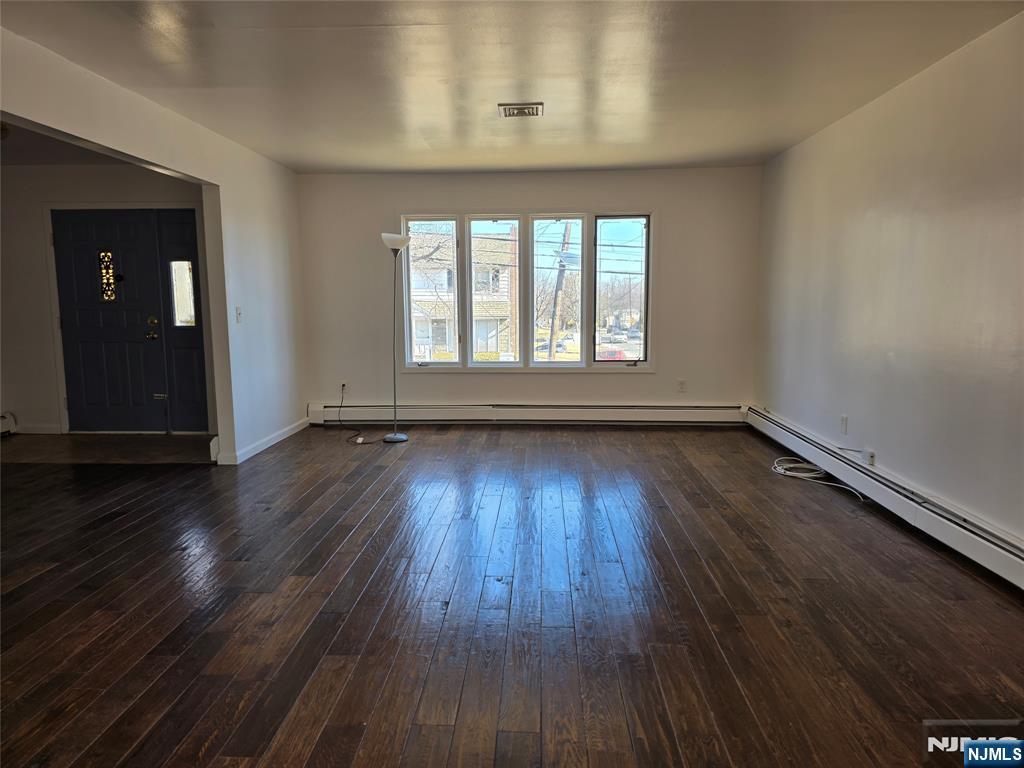320-322 Williams, Unit 322 Hasbrouck Heights, NJ 07604 - Photo 2 of 12 an empty room with wooden floor and windows