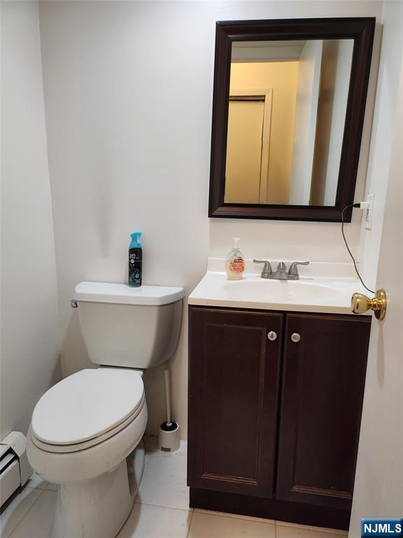 320-322 Williams, Unit 322 Hasbrouck Heights, NJ 07604 - Photo 4 of 12 a bathroom with a toilet sink and mirror