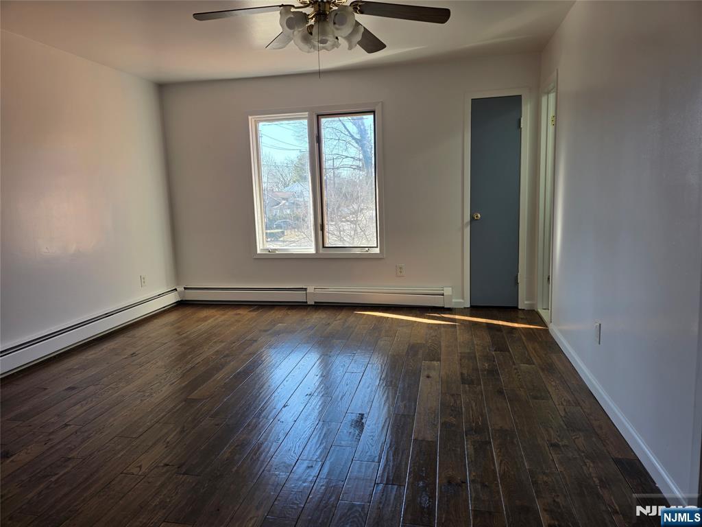 320-322 Williams, Unit 322 Hasbrouck Heights, NJ 07604 - Photo 7 of 12 an empty room with wooden floor chandelier and windows