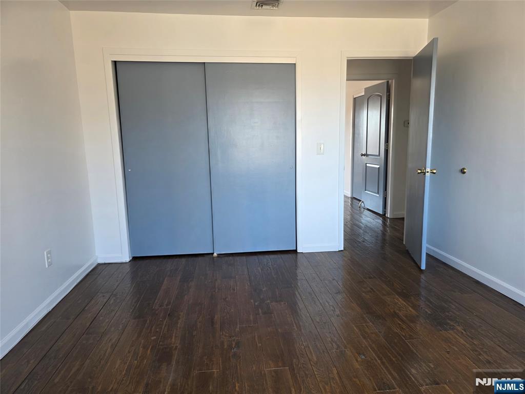 320-322 Williams, Unit 322 Hasbrouck Heights, NJ 07604 - Photo 8 of 12 an empty room with wooden floor & closet area