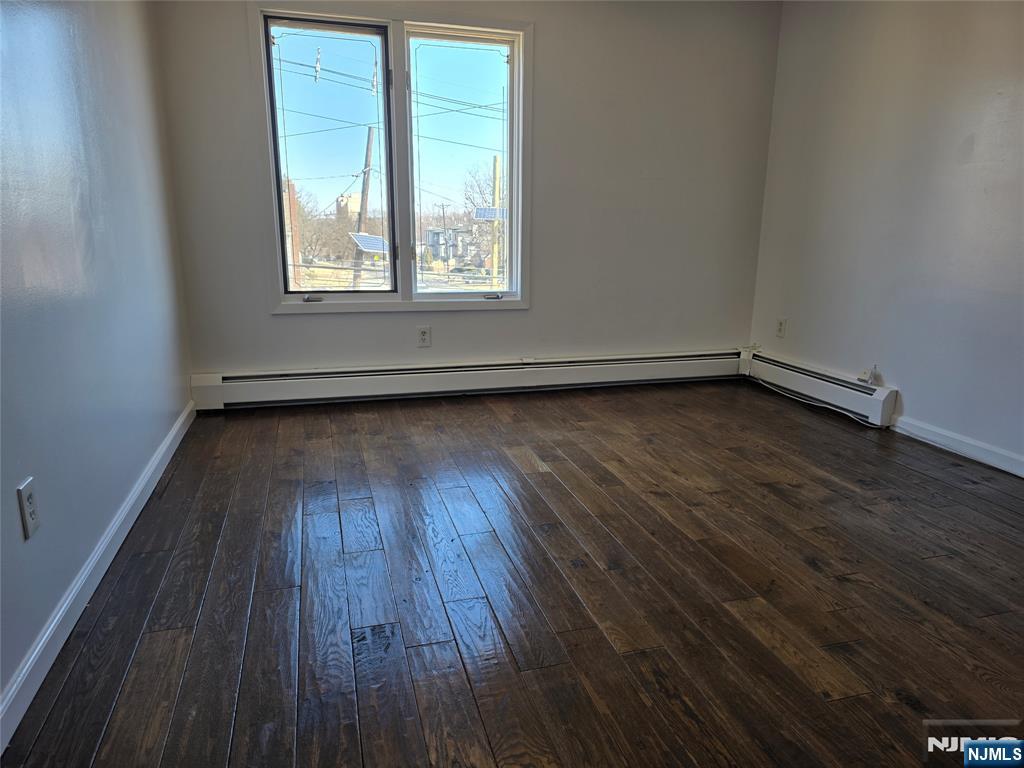 320-322 Williams, Unit 322 Hasbrouck Heights, NJ 07604 - Photo 9 of 12 an empty room with wooden floor and windows