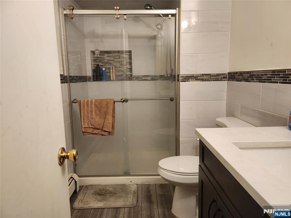 320-322 Williams, Unit 322 Hasbrouck Heights, NJ 07604 - Photo 10 of 12 a bathroom with a sink a toilet and shower