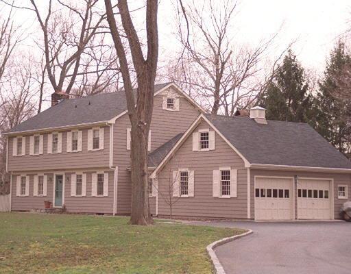 110 Cedar Road Wilton, CT 06897 - Photo 1 of 1 a front view of a house with a yard